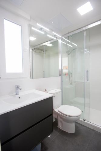 a bathroom with a sink and a toilet and a shower at La Pedriza One in Manzanares el Real