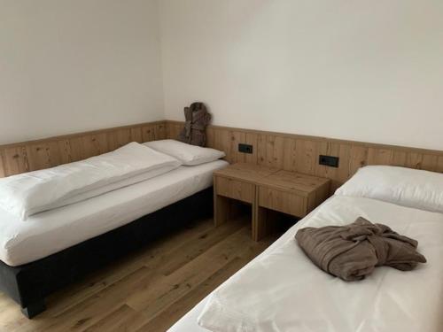 two beds sitting next to each other in a room at Dependance Residence Altea in Ortisei