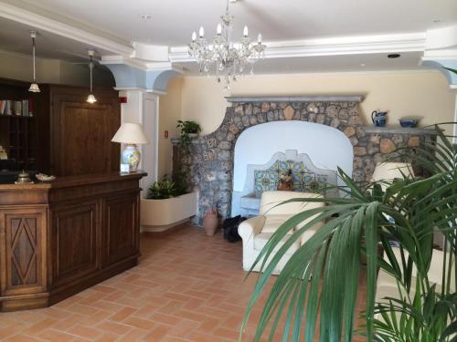 a living room filled with furniture and a fireplace at Hotel Villa Delle Meraviglie in Maratea