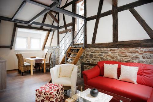 a living room with a red couch and a table at Winneburger Hof in Ernst