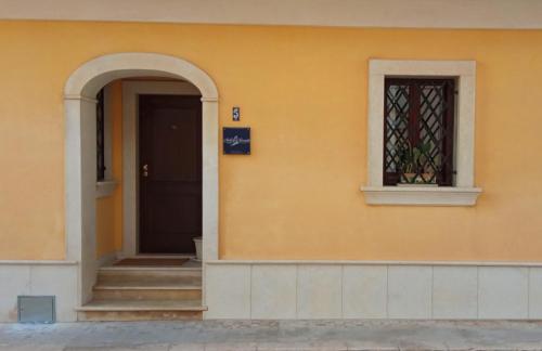 マリーナ・ディ・ラグーザにあるMolo di Levante - Rent Apartmentの黄色の建物