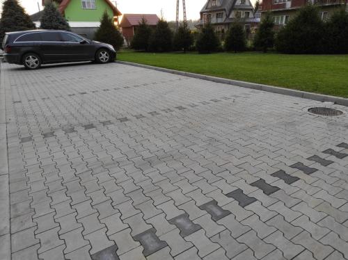 a parking lot with a car parked on it at Miętusia Przystań - Wynajem Pokoi in Ciche