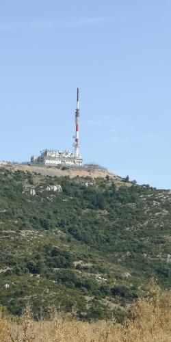 a lighthouse on the top of a hill at Chambres d'Hôtes Le Mimosa in Saint-Saturnin-de-Lucian