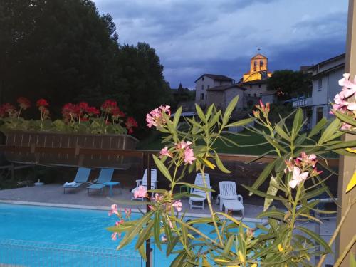 a view from the balcony of a resort with a swimming pool at Le Mas de Servant Roulottes et chambres d'hôtes in Auberives-en-Royans