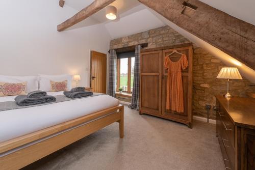 a bedroom with a large bed and a window at Somerset Country Escape - Luxury barns with hot tubs in Hatch Beauchamp