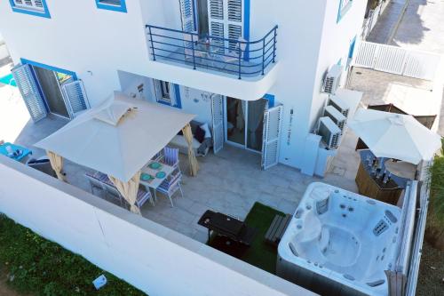 an aerial view of a building with a table and umbrella at Villa Kapparis Sunrise in Paralimni