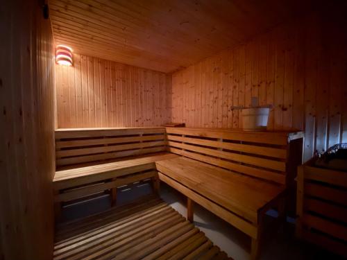 a wooden bench in a sauna with a light on at Villa Kapparis Sunrise in Paralimni