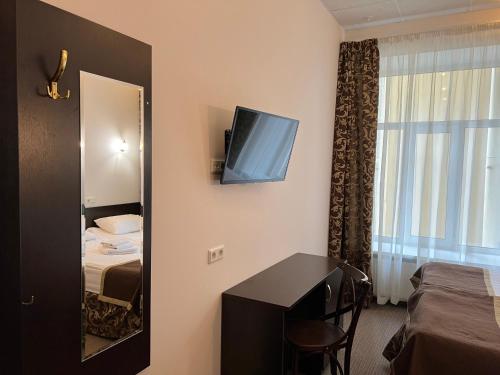 a hotel room with a bed and a mirror at Demidov in Saint Petersburg