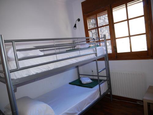 a couple of bunk beds in a room at Xarpell-Vacances Pirinenca in Encamp
