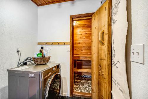 a washer and dryer in a room with a wooden door at Hyak Hygge in Snoqualmie Pass