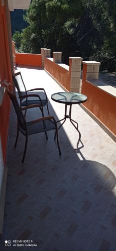a patio with a table and a chair on a patio at Apartments Dalibor in Brna