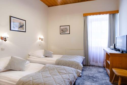 Postel nebo postele na pokoji v ubytování Pokoje Krupówki 13 - Hotel Sabała