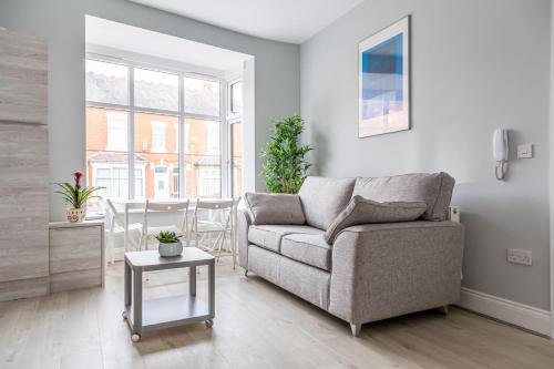 a living room with a couch and a table at Stunning property fully refurbished in Birmingham