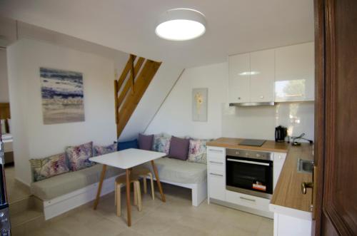 a kitchen with a table and a small table in a room at Villa Dimitris in Palekastron