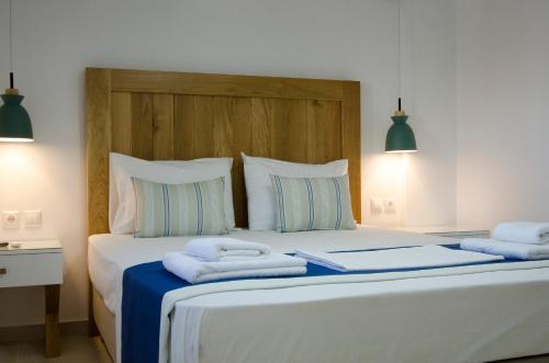 a bedroom with a bed with towels on it at Villa Dimitris in Palekastron