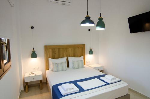 a bedroom with a bed with two towels on it at Villa Dimitris in Palekastron