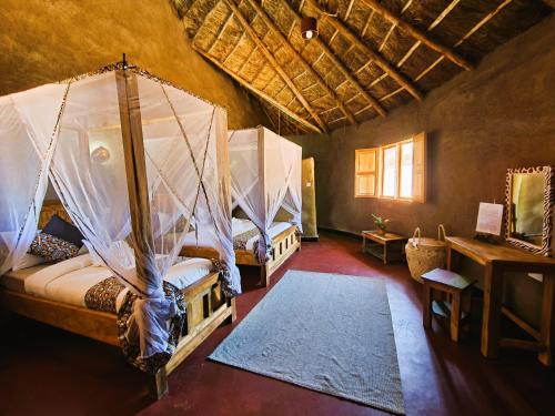 A bed or beds in a room at Africa Safari Maasai Boma