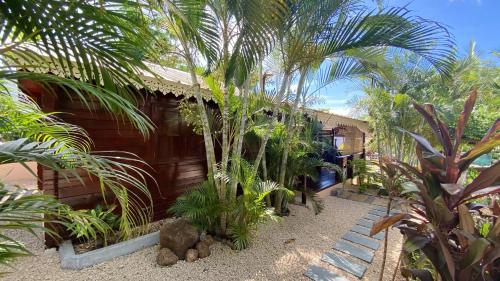 a building with palm trees in front of it at Charming House in Albion with Shared Pool in Albion