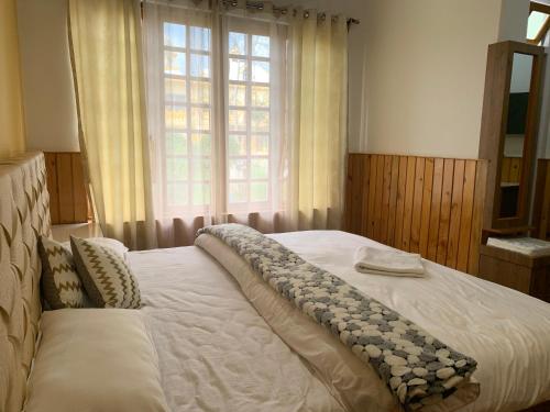 NOLINA BOUTIQUE HOMESTAY tesisinde bir odada yatak veya yataklar