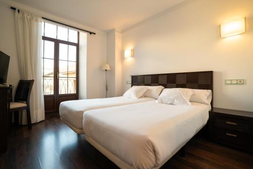Кровать или кровати в номере Hotel Rincón del Conde