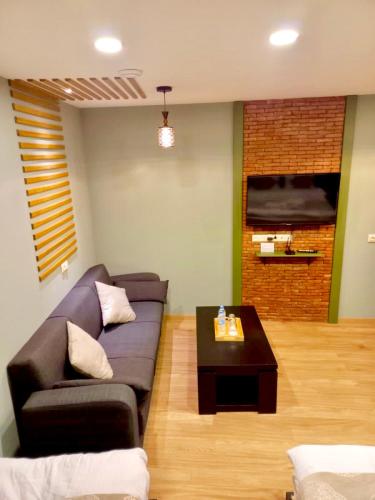 a living room with a couch and a coffee table at Old Town Mtatsminda in Tbilisi City