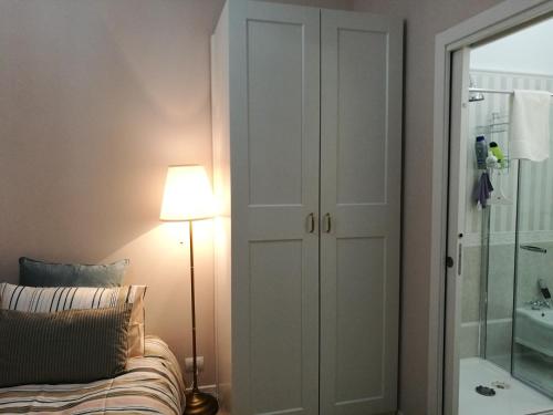 a bedroom with a bed and a lamp and a closet at Central 2 bedrooms 2 bathrooms in Ancona