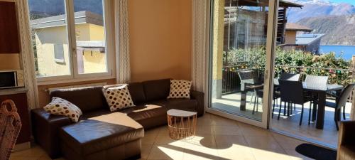 a living room with a couch and a balcony at Casa Favorita in Colico