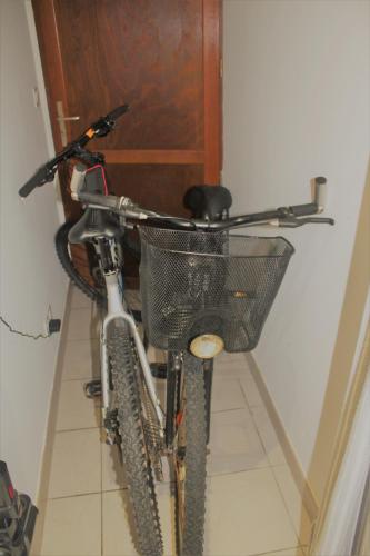 a bike with a basket is parked in a room at La Belle Etap', gîte classé 3 étoiles in Étaples