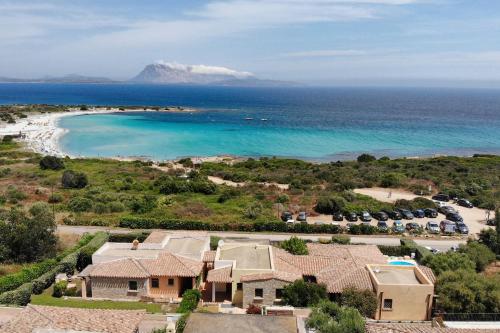 an aerial view of a house and the beach at Villa Isuledda Prestige in San Teodoro