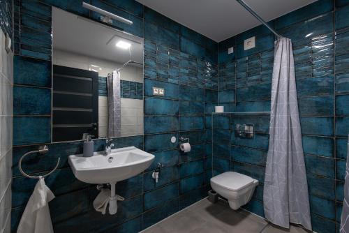 a bathroom with a sink and a toilet at Theresa Vendégház in Kiskunmajsa