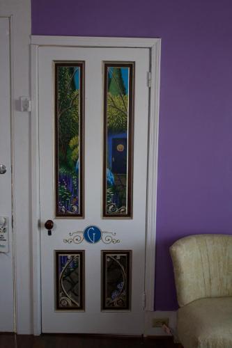 a door with four stained glass windows on it at The Gridley Inn B&B in Waterloo
