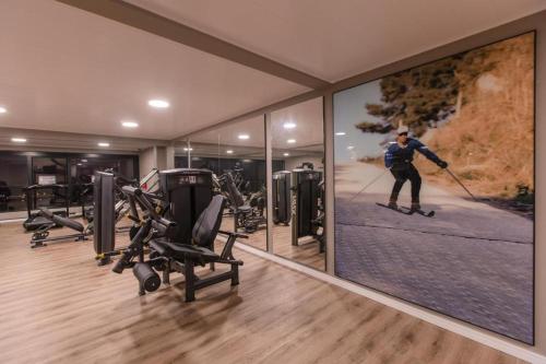 a room with a man on skis in a gym at Dall'Onder Ski Hotel in Garibaldi