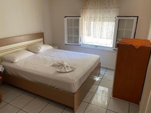 a bedroom with a bed with a plate on it at Penelope House in Skala Kallirachis