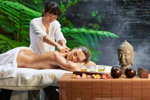 a woman getting a massage from aitating woman in a spa at Thai Sun Hostel in Prague