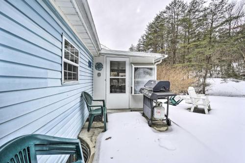 a snow covered patio with a grill and chairs on a house at Rustic Family Home and Acreage about 20 Mi Hocking Hills in Lancaster