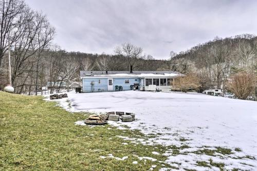 two cars parked in the snow in front of a house at Rustic Family Home and Acreage about 20 Mi Hocking Hills in Lancaster