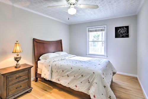 a bedroom with a bed and a dresser and a window at Immaculate Suwanee House with Pool and Game Room! in Suwanee