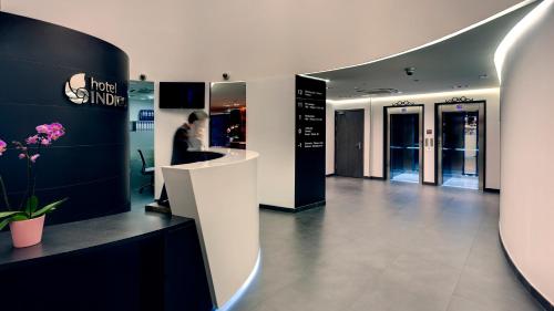 a woman is standing in a lobby of a store at Hotel Indigo Madrid - Gran Vía by IHG in Madrid