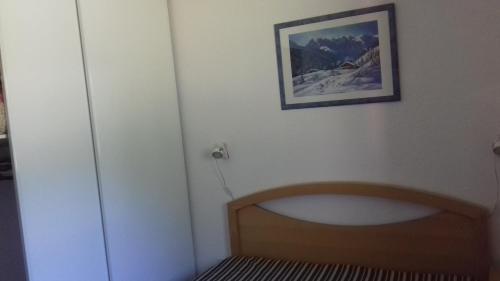 a bathroom with a tub and a picture on the wall at Appartement 24 Les Chalets du Jardin Alpin in La Salle Les Alpes