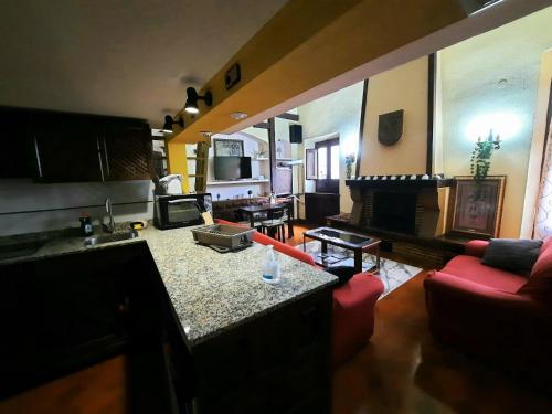 a living room with a kitchen and a living room with a fireplace at Apartamento medieval en el Camino De Santiago in Estella