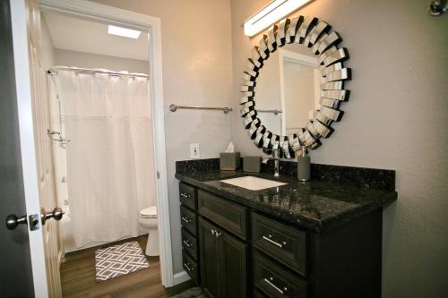 a bathroom with a sink and a mirror at B306 - Endless Summer in Oceanside