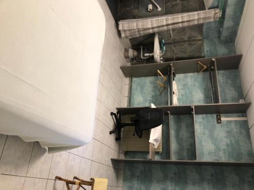a bathroom with shelves and towels on the wall at Hôtel De La Mare -restaurant pour les clients sur réservation in Avrigny