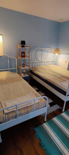 two beds sitting next to each other in a bedroom at Namaste къща в село Камилски дол in Kamilski Dol