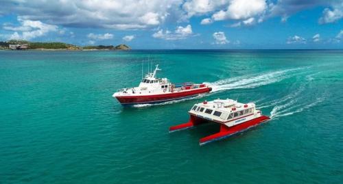 two boats in the water in the ocean at Captivating 1-Bed Cottage in Codrington in Dulcina