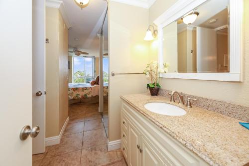 a bathroom with a sink and a mirror at E109 - Starfish Villa in Oceanside