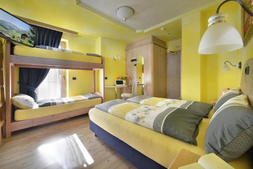 Ένα ή περισσότερα κρεβάτια σε δωμάτιο στο Hotel Piccolo Mondo