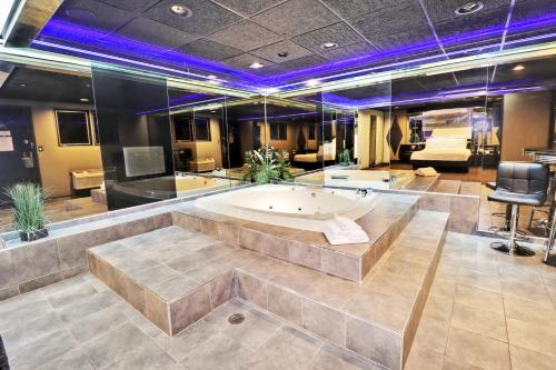a large bath tub in a room with purple lights at Hollywood Motel in Farmingdale