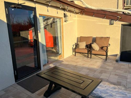 a patio with a couch and a coffee table at Hollywood Motel in Farmingdale