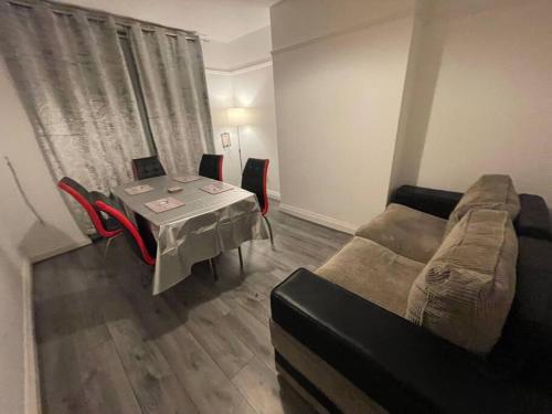 ein Wohnzimmer mit Sofa und Tisch in der Unterkunft Large Beautiful 3 Bed house in City of Birmingham in Birmingham