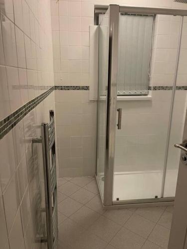 a shower stall in a bathroom with a white at Large Beautiful 3 Bed house in City of Birmingham in Birmingham